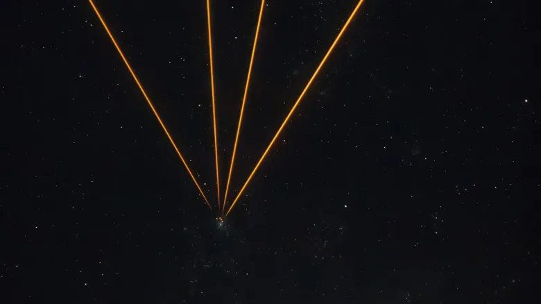 A series of golden lines converging to one point in a starry night in the center of the image