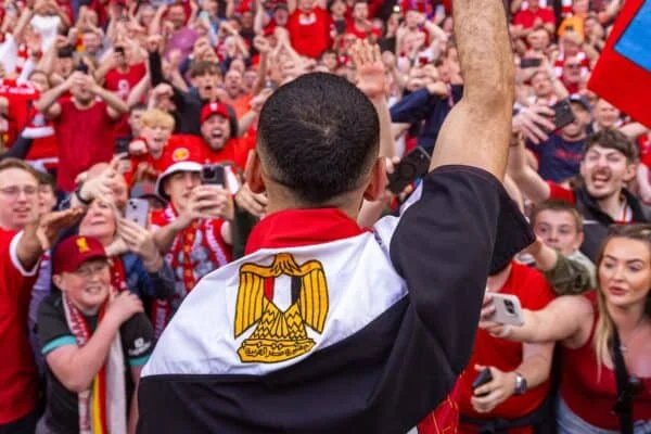 LIVERPOOL ENGLAND - Sunday April 27 2025 Liverpool039s Mohamed Salah draped in a flag of Egypt celebrates with supporters after winning the League Title after the FA Premier League match between Liverpool FC and Tottenham Hotspur FC at Anfield Liverpool won 5-1 Photo by David RawcliffePropaganda